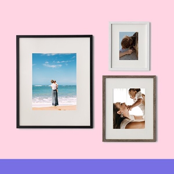 three wood frames on pink background